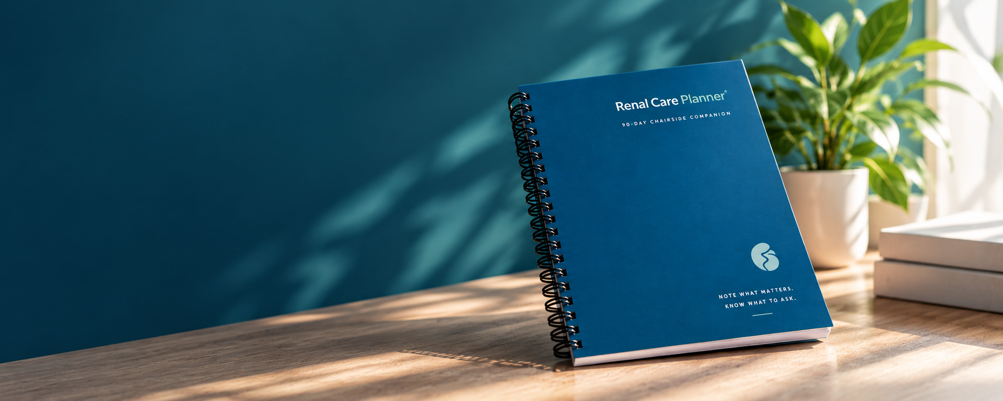 Renal Care Planner 90-Day Chairside Companion spiral-bound notebook on a wooden desk